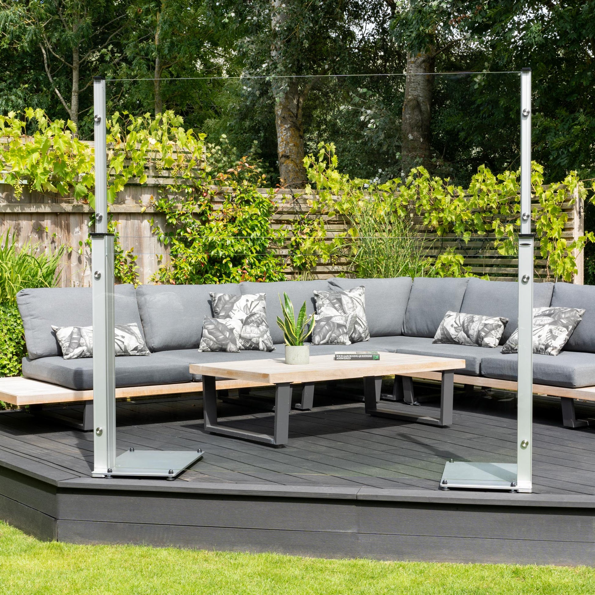 6ft extended glass panel with aluminium feet stood on a raised decked platform