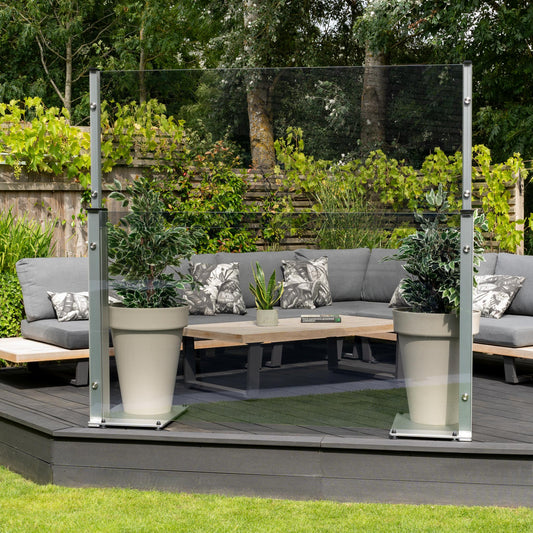 UV blue tinted glass panel extended with freestanding planter weights on a decked platform