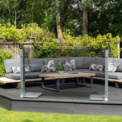 UV tinted freestanding glass screen on a decked platform infront of a garden sofa