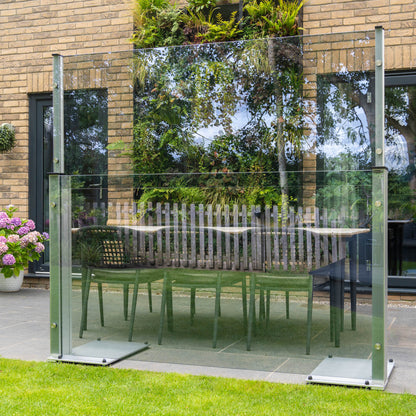UV blue tinted freestanding glass panel on a patio in front of a dining set