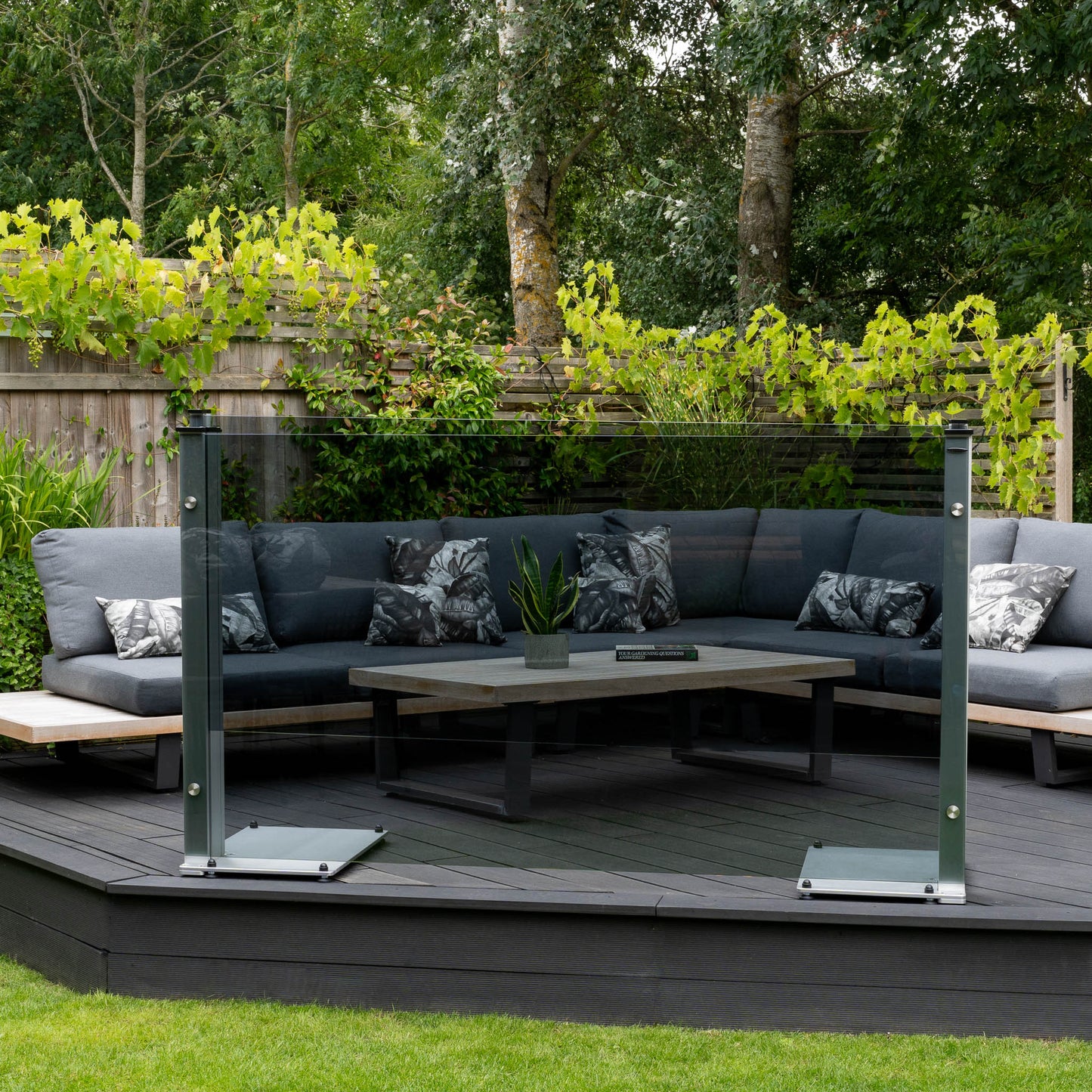 Freestanding balustrade with dark grey tinted glass on a raised decked platform