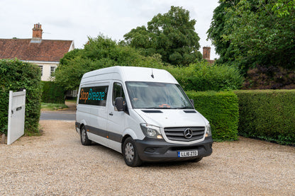 Delivery Van pulling into hedge lined driveway